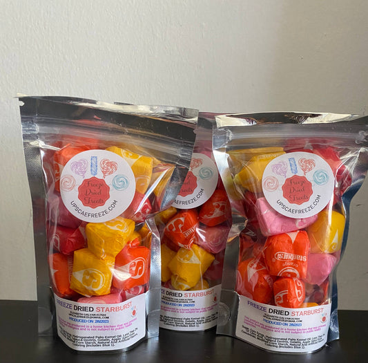 Three clear bags of freeze dried Starburst candies with round colorful labels; available in multiple sizes.