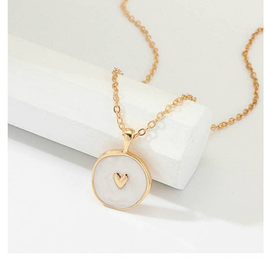White Gold Heart Enamel Necklace with 16" gold chain, round pendant, white enamel center, gold heart. 3" extender included.