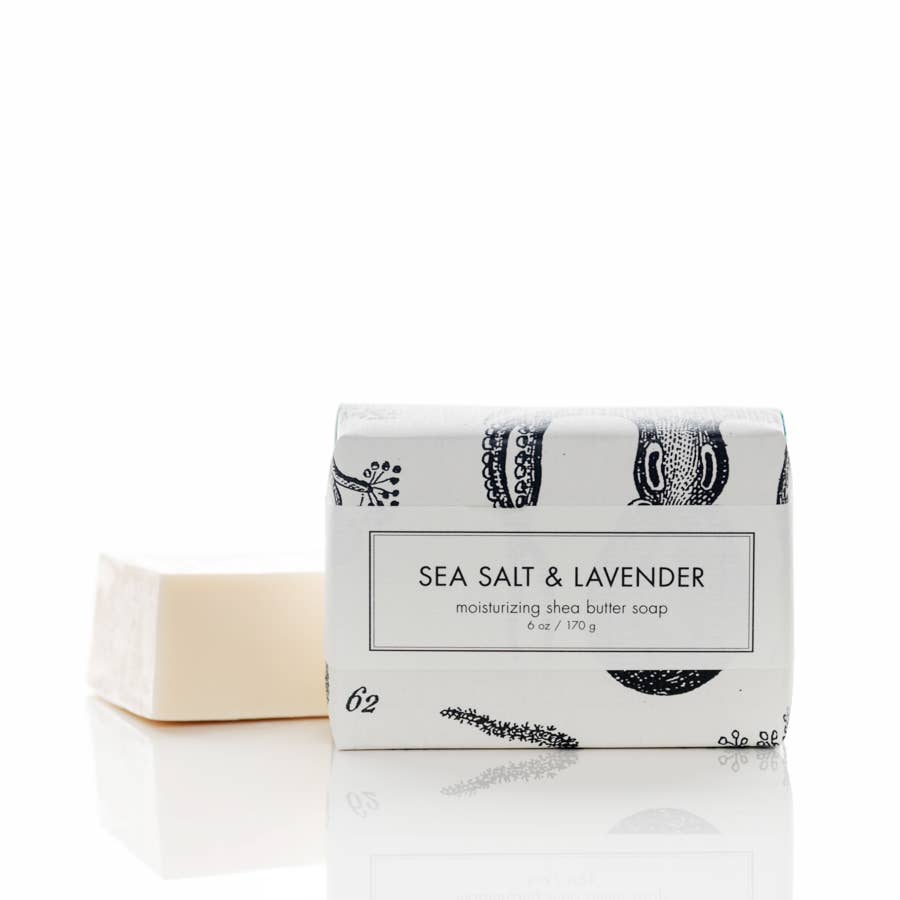 The product is a Sea Salt & Lavender Soap - Bath Bar that comes in an elegantly packaged box with black and white botanical designs. The soap features rejuvenating sea salt and relaxing lavender fragrance, promising a luxurious bath time experience. It comes in one standard size suitable for personal use.