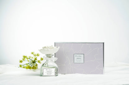 The Sunshine Rose Ceramic Flower Diffuser Gift Set - Serenity includes a glass bottle with ceramic flower cap; available in various sizes.