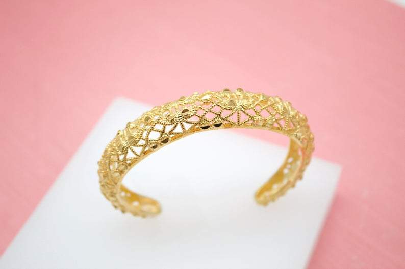 This is an 18K Gold Filled Greek Jeweled Encrusted Wrist Cuff Bangle Bracelet (B3). It has a delicate, intricate lace-like pattern. The size of the bracelet is adjustable to fit any wrist size.