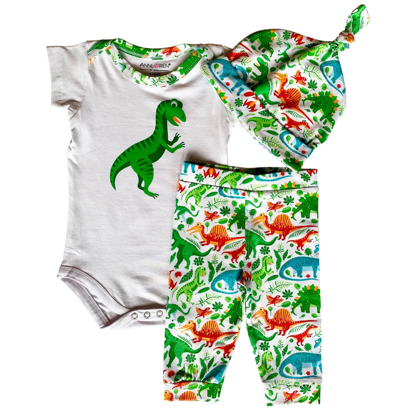 Set of three - onesie, beanie, and pants- all patterned with dinosaurs and white accents. Oneside is short sleeved and has a snap closure. Hat is knotted at the top.