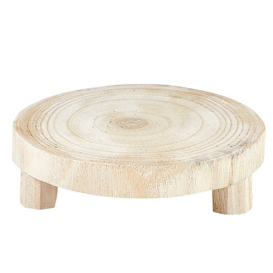 Small Natural Wood Riser G2627: round Paulownia wood, visible grain, three short legs. Available in small size.