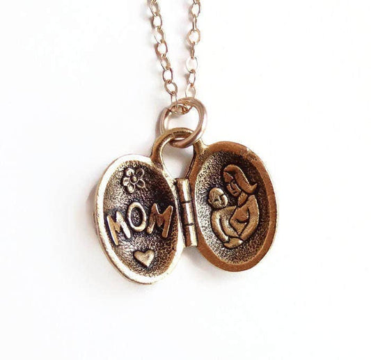 Gold plated open locket with "MOM," heart, flower, and engraved mother with baby. Available sizes: 16", 18", 20".
