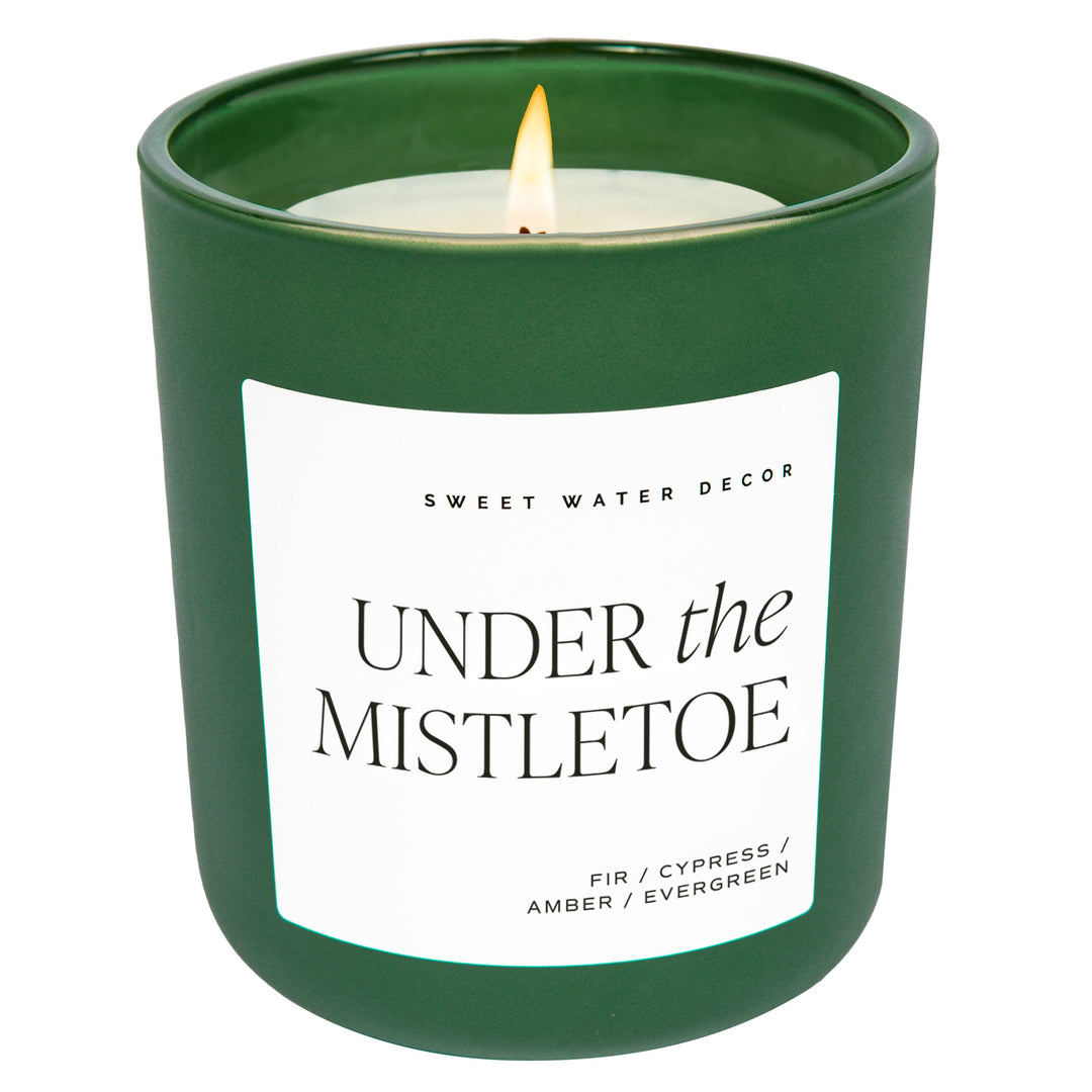 Under the Mistletoe 15 oz soy matte candle in a green glass jar.