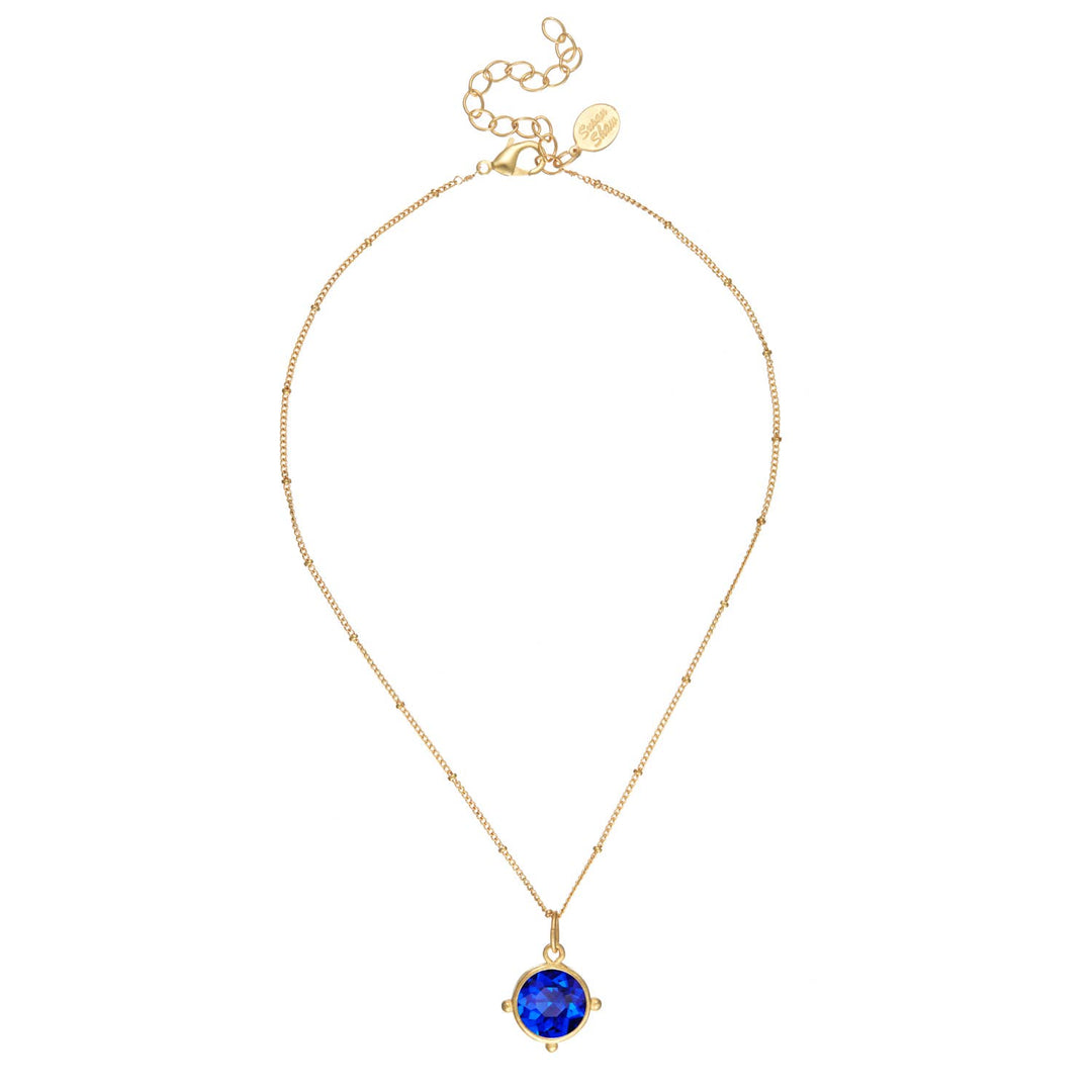 Blue round crystal pendant in gold bezel on adjustable chain with clasp and tag. Handcast. Available in 16", 18", and 20".
