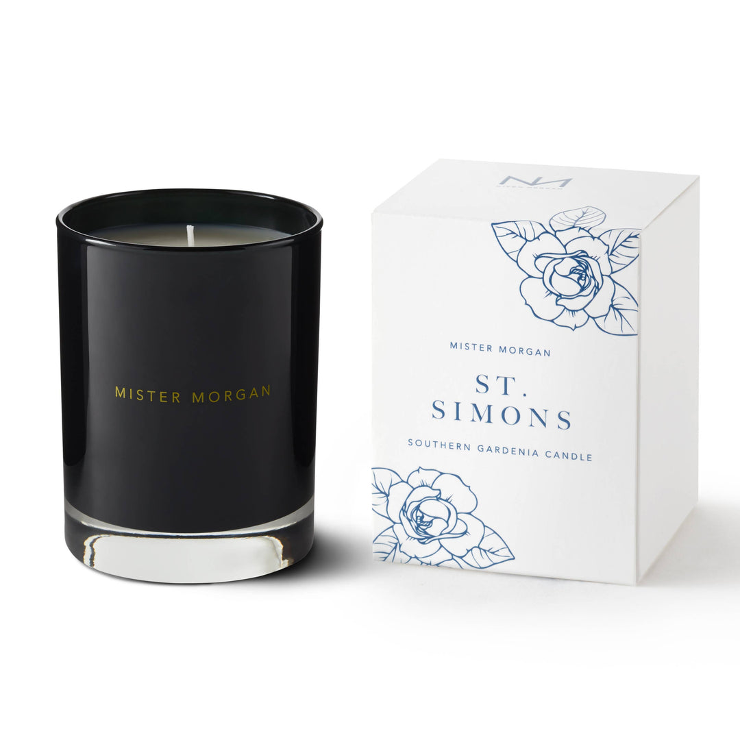 Black glass candle labeled "St. Simons Southern Gardenia Candle." Available in 8oz and 16oz sizes.