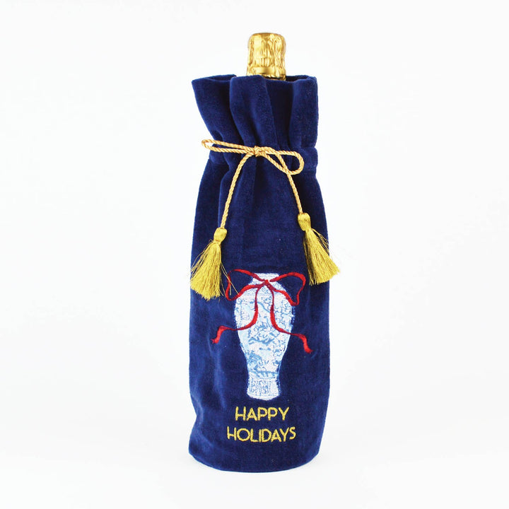 Navy blue Ginger Jar wine bag with red ribbon, “HAPPY HOLIDAYS” text, and gold drawstring.
