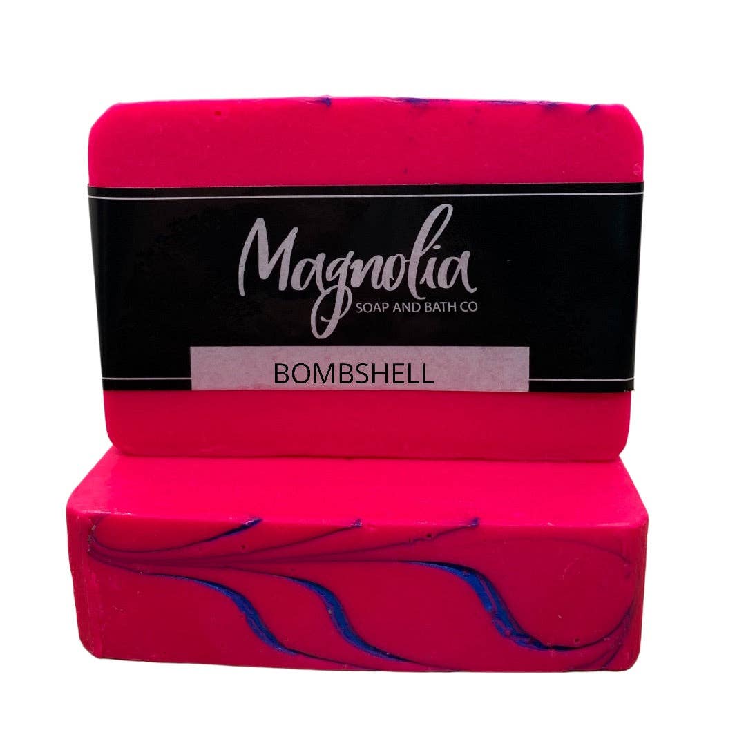 The product is two vibrant pink bars of Bombshell Soap by Magnolia Soap and Bath Co., featuring a stunning orchid blossoms design. Comes in standard soap bar sizes.