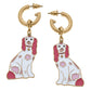 Gold hoop earrings with white and pink enamel spaniel dog charms, worn gold plating, base metal. Sizes: One size.