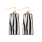 This product consists of a pair of trendy dangling earrings with fish hook attachments. The earrings feature an eye-catching animal print design with black and white stripes framed by thin gold borders. They're made from leather for added durability and style. These earrings are one size fits all, making them versatile wearable accessories.