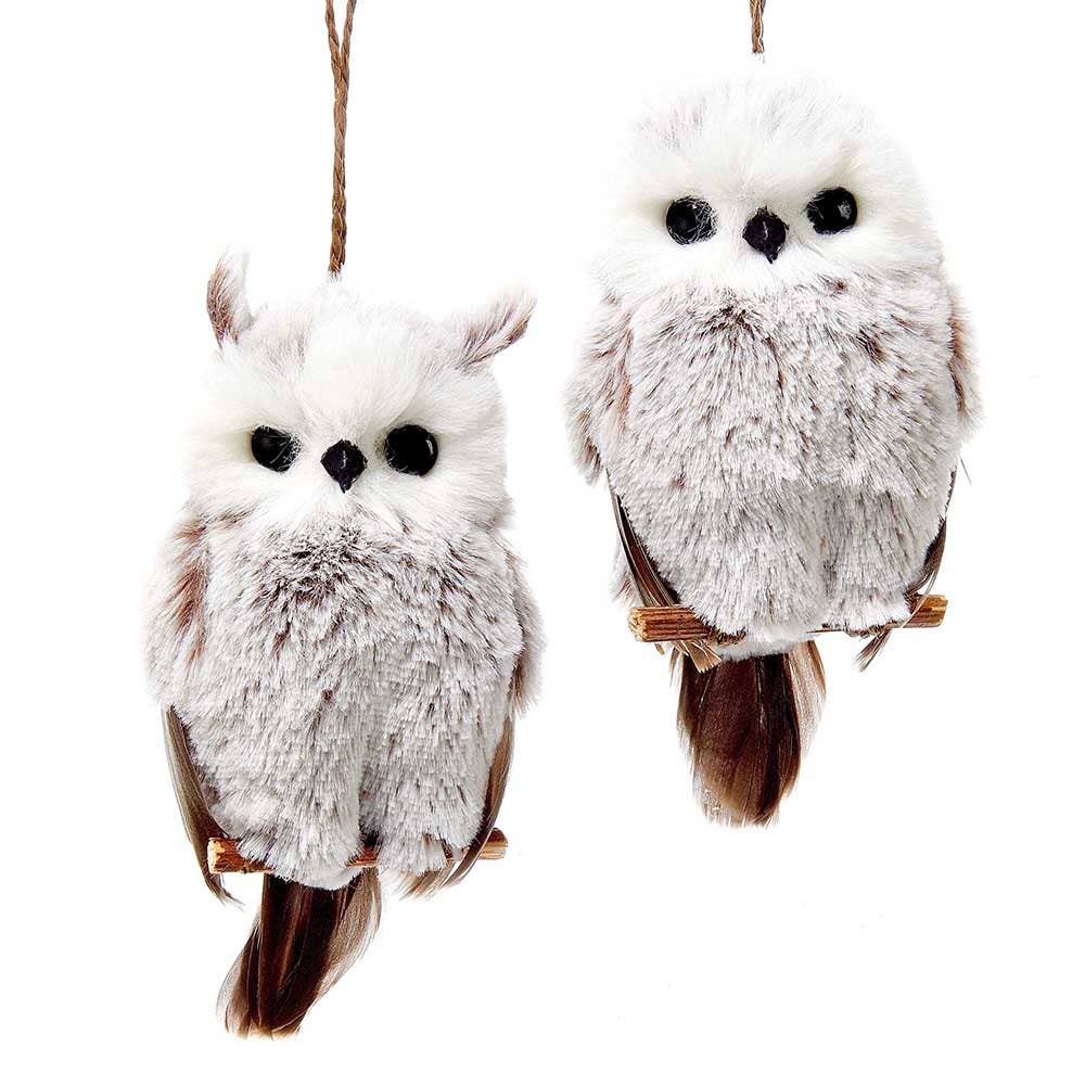 Two fluffy brown and white hanging owl ornaments on branches.