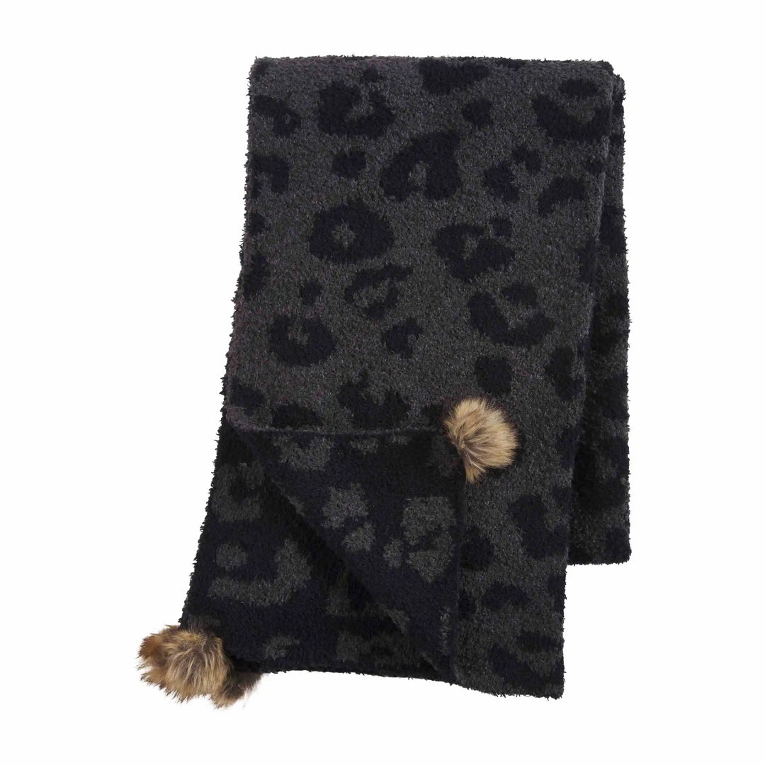 Dark gray leopard chenille scarf with two brown pom-poms on one corner. Available in multiple sizes.