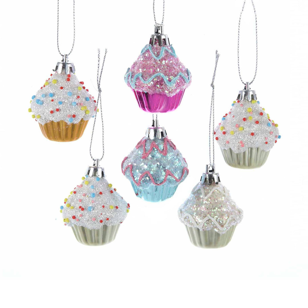 Six plastic cupcake ornaments with glitter and colorful sprinkles.