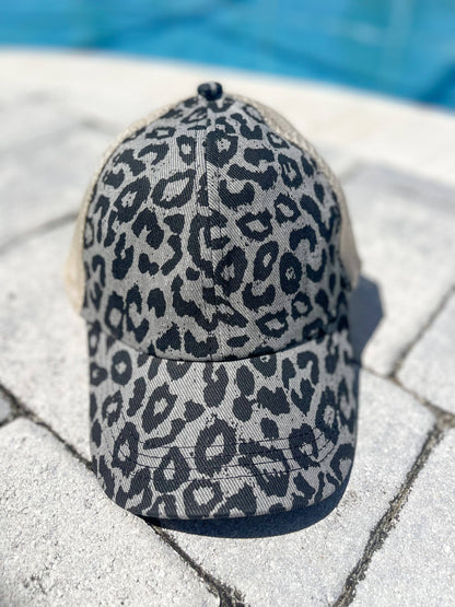 The Go Wild "Gray" Trucker Hat with black and gray leopard print, adjustable velcro. Available in one size fits most.
