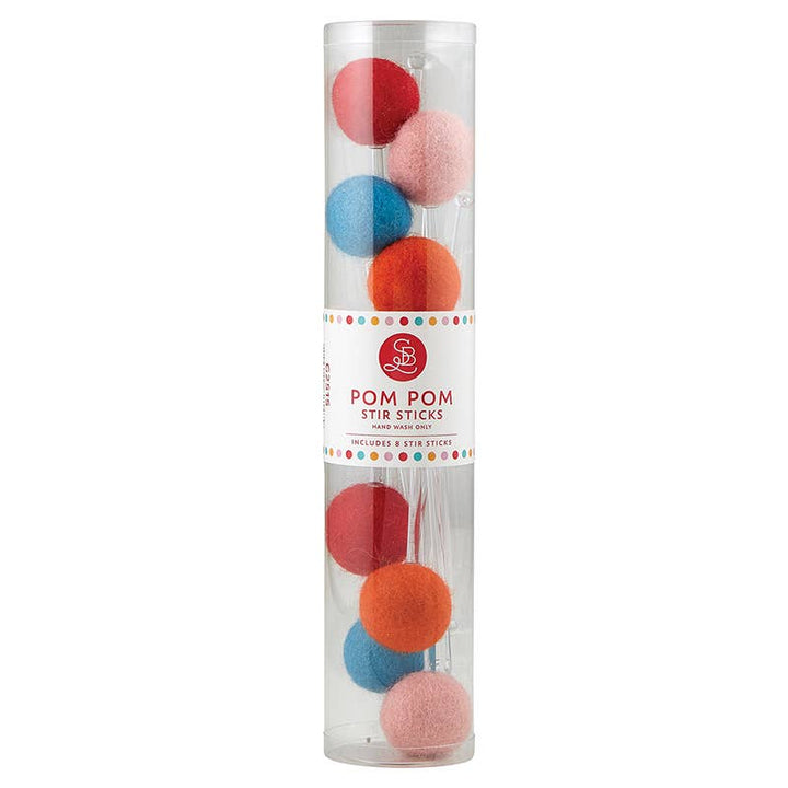 Eight Christmas cocktail stir sticks with red, blue, and orange pom-poms in a clear plastic tube.