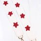 White crossbody strap with burgundy beaded stars, gold lobster clasps. Available sizes: 41", 48".