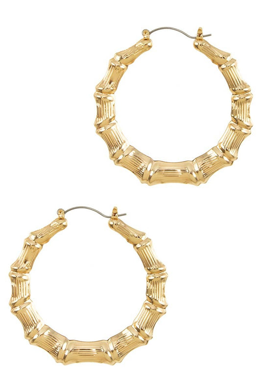 These Bamboo Style Hoop Earrings are intricately designed with distinct segments. The earrings are crafted from durable material and have a size of 50mm. Perfect for adding an elegant touch to any outfit, these earrings flaunt a natural bamboo motif for a unique style statement. They secure comfortably with latch backs for worry-free wear.