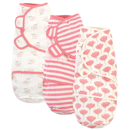 Three Touched by Nature Organic Cotton Swaddle Wraps in Tulip: one with pink and white stripes, one with a floral pattern, and one with pink roses, all featuring adjustable fasteners to promote a safe sleep environment.