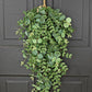 This product is a 29 inch Teardrop-Mixed Eucalyptus wreath in lush green color. It features a gold ring for hanging. Ideal for enhancing door decor with a natural touch.