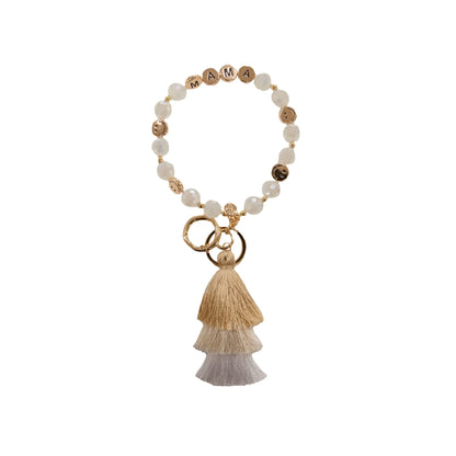 Beaded bracelet keychain with white and gold beads, “MAMA” letters, gold rings, gradient tassels. Sizes: S, M, L.