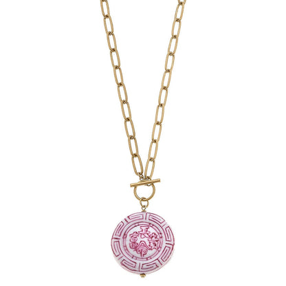 Gold chain with elongated links, toggle clasp, pink and white round pendant with patterns. Available in 16", 18", and 20".