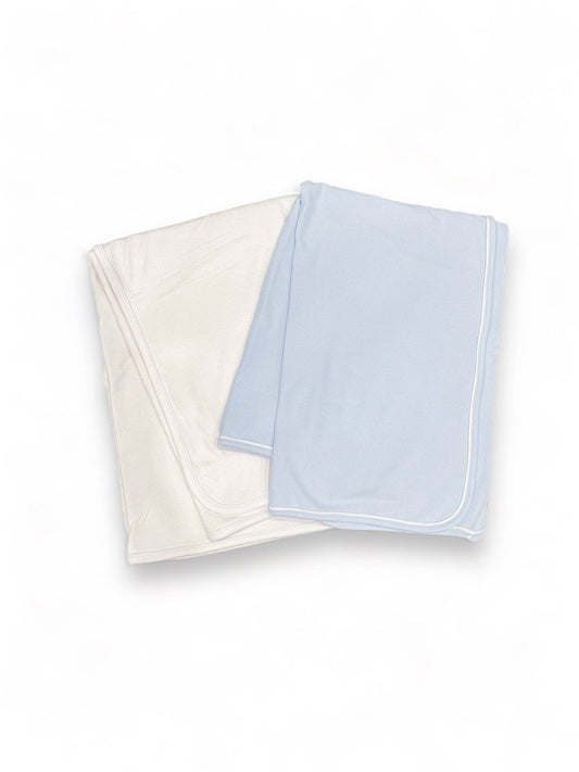 Two folded double layered White Baby Blankets with Piping, one in cream and the other in light blue, placed on a white background.