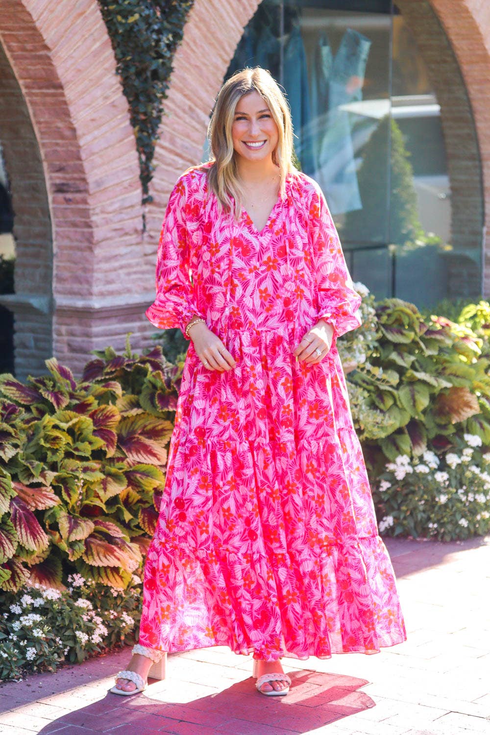 The Ruby Long Sleeve Maxi Dress features lined pockets and a V-neck with a tie. It's available in various sizes.