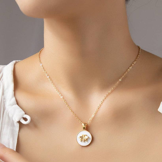 Ilina Gold Bee White Enamel Pendant Necklace: gold chain, round white pendant with petite gold bee. Sizes: S, M, L.