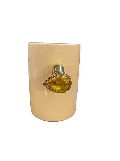 Cream ceramic mug with gold ring-shaped handle and large yellow gemstone. Available size: standard mug size.