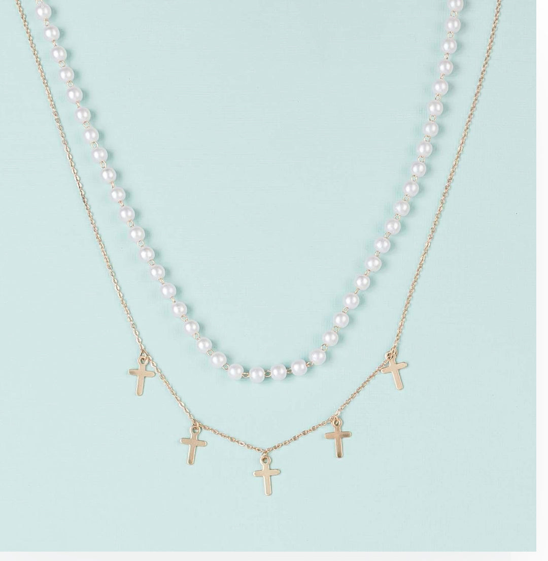 The Callie Necklace: brass-plated gold chain with five small gold cross pendants. Available in 16" and 18" lengths.