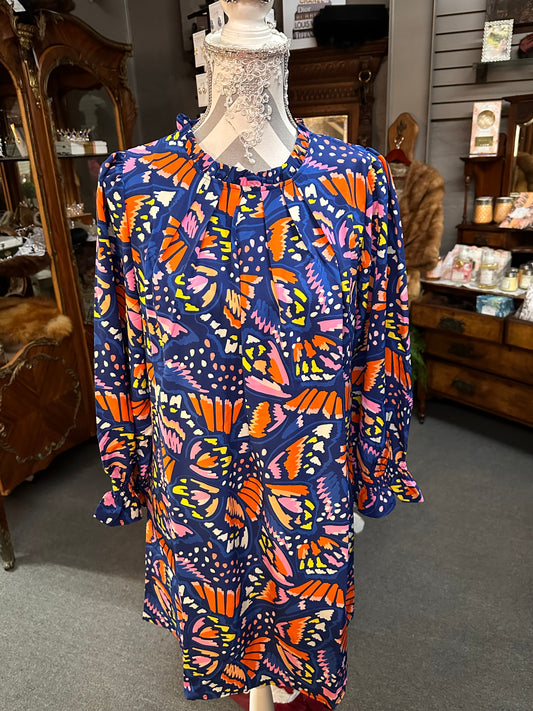 The So Fly - Blue Caroline Dress is a vibrantly printed dress with large, colorful butterfly designs. It's available in various sizes.