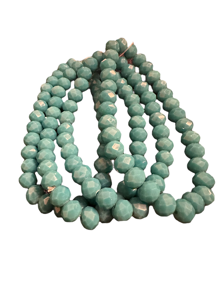Glass beaded strand bracelet with round, faceted turquoise beads. Available sizes: S, M, L.
