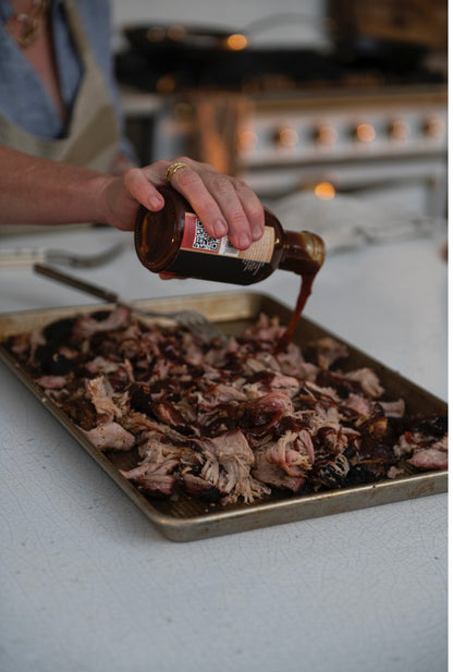 Honey Habanero BBQ Sauce being poured from bottle. Available in 12oz and 24oz sizes.
