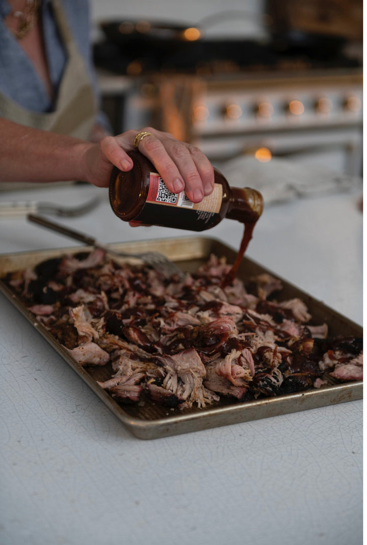 Honey Habanero BBQ Sauce being poured from bottle. Available in 12oz and 24oz sizes.