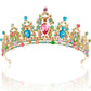 Gold tiara with ornate patterns, vibrant stones, and a central pink heart gem. Available in small, medium, and large sizes.