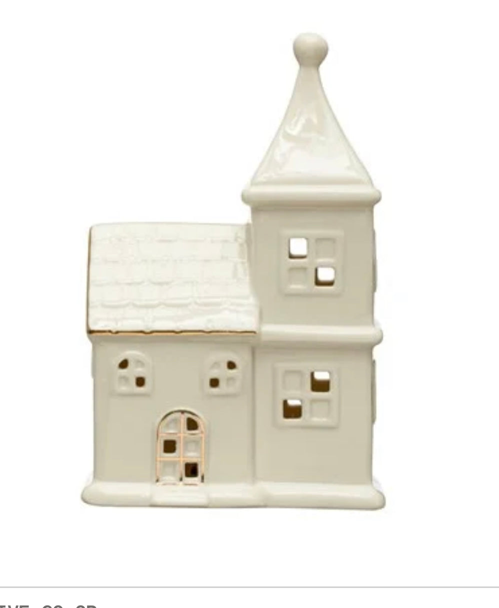 Off-white stoneware LED house with pointed tower, gold electroplating, and cut-out windows.