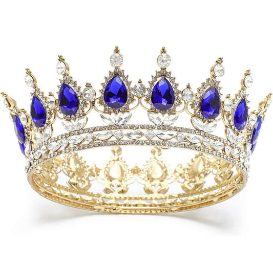 Vintage gold crown with teardrop blue gems, clear crystals, and ornate details. Available in small, medium, and large.