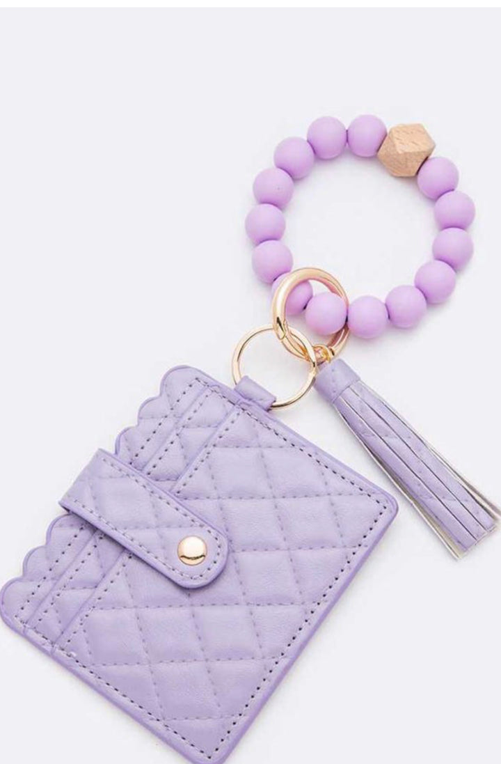 Quilted lavender card case with snap, purple beaded wristlet, gold ring, tassel. Nickel-safe. Sizes: S/M/L.