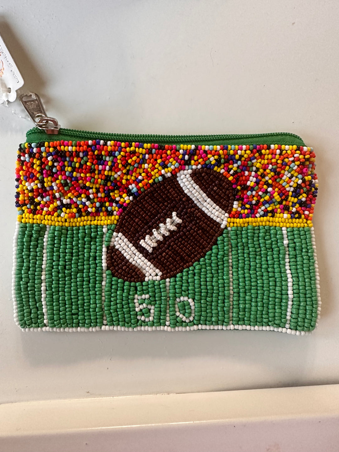 Beaded football sequin wallet with green field, white "50" yard line, green zipper. Sizes available: Small, Medium.