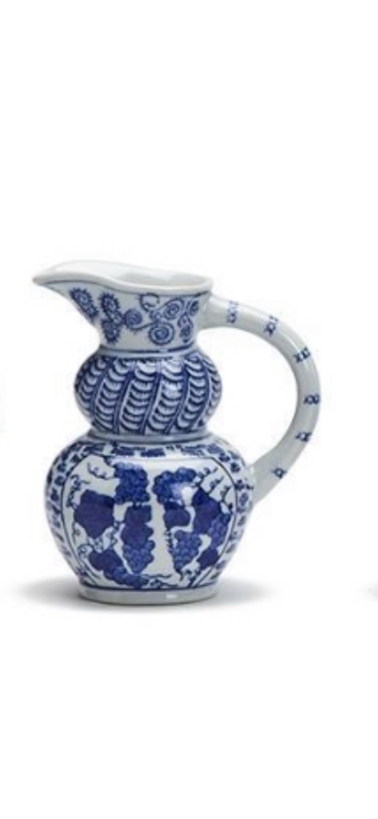 White ceramic pitchers with blue floral and geometric designs, curved handle; available in small sizes.