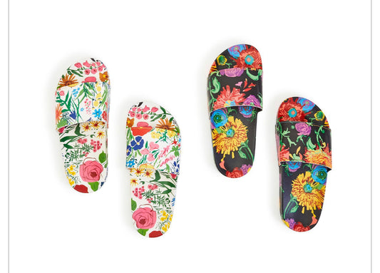 These molded Eva slides come in two different styles one is white with floral the white with floral has pink roses blue daisies grass the second stall the background is black with marigolds yellow miracles purple roses these slides have a band across the top of the foot
