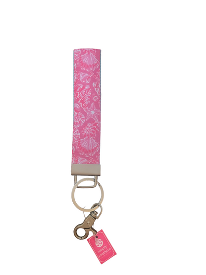 Pink fabric wristlet keychain with white seashells, silver key ring, lobster clasp, small pink tag. Sizes: one size.