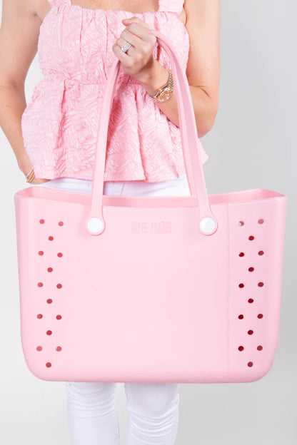 Jane Marie Multi Purpose Tote: large light pink rubber bag with round holes, white buttons. Available in small, medium, large.