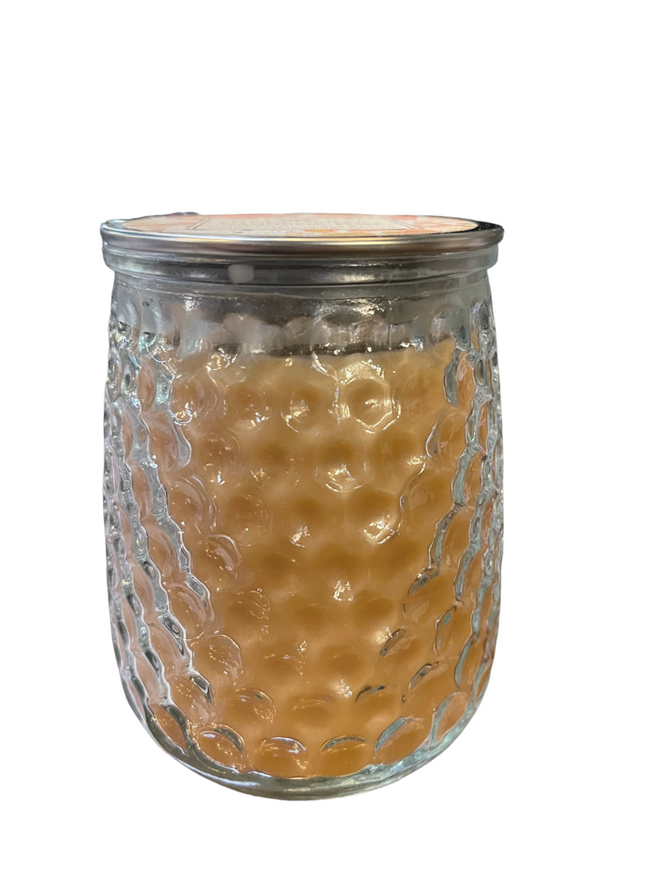 Cashmere Kiss candle, 13 oz., in textured glass jar with light orange wax and metal lid. Available in 13 oz. size only.