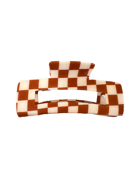 Rectangular claw clip with brown and white checkerboard pattern, wide opening, flat top handle. Sizes: small, medium, large.