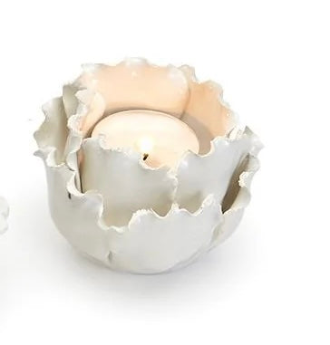 White ceramic tea light candleholders with ruffled, petal-like edges. Available sizes: small and medium.