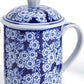 Hand-painted blue porcelain mug with white floral pattern, handle, lid. Size options available for model 53592-20.
