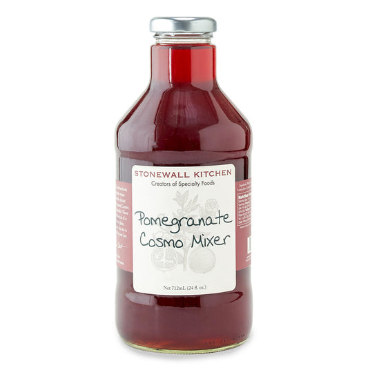 Clear glass bottle with red liquid, labeled "Pomegranate Cosmo Mixer 24 oz" in handwriting, fruit art on white label.