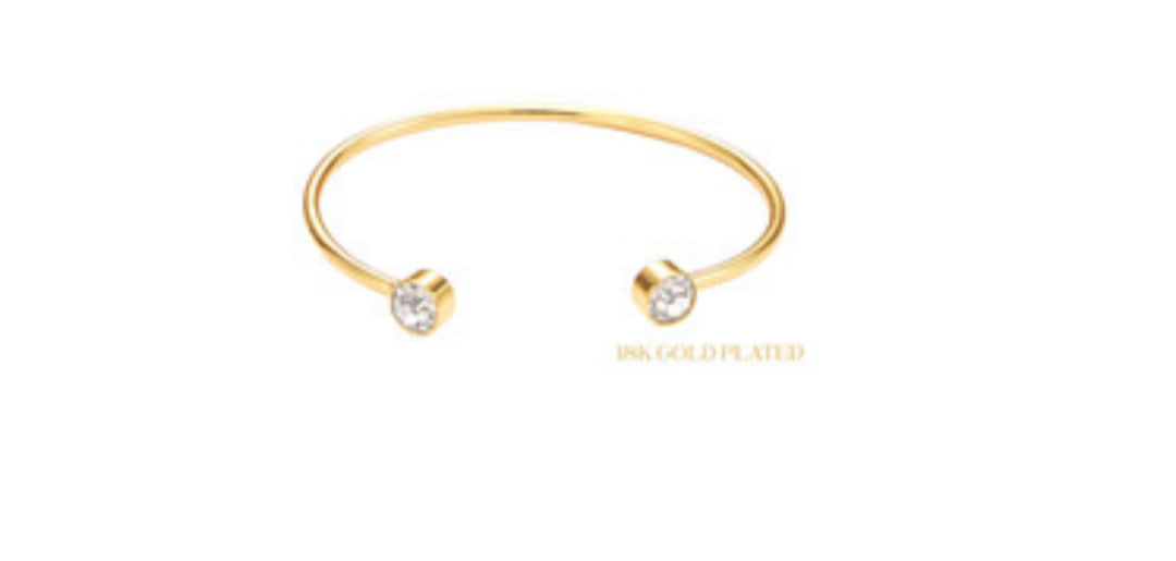 The product is an 18K Gold Plated Round Cuff featuring Clear Crystal End Accents. It is delicately designed to elegantly adorn your wrist. The cuff&